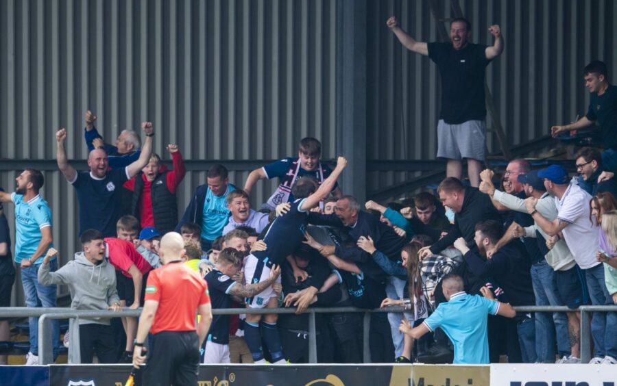 Paul McGowan celebrates with Dundee fans at Dens Park after scoring against Hibs.