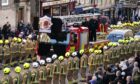 The coffin of Barry Martin arrives on a fire engine outside St Giles' Cathedral. Image: PA