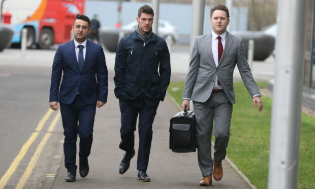Jason Grant, centre, arrives at the tribunal hearing alongside his legal team from Dundee-based MML. Image: Gareth Jennings/DC Thomson