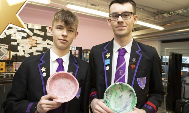 St John's Academy pupils Noah Law and Diesel Ferguson have been given Courier Gold Stars for their hands-on recycling project.