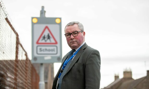 Councillor Craig Fotheringham with permanently flashing safety signs at Strathmore Primary School, Forfar. Image: Kim Cessford/DC Thomson
