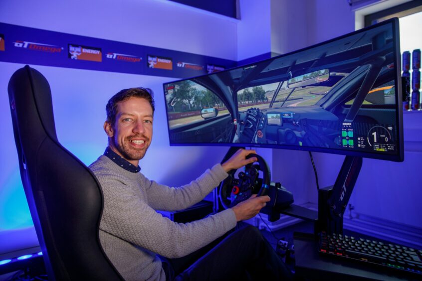 Dundee City Council leader John Alexander playing a driving game