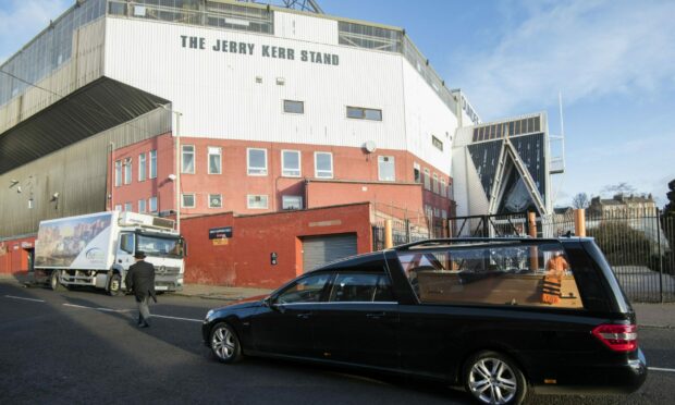 The funeral cortege of Randal Lumb passes Tannadice.