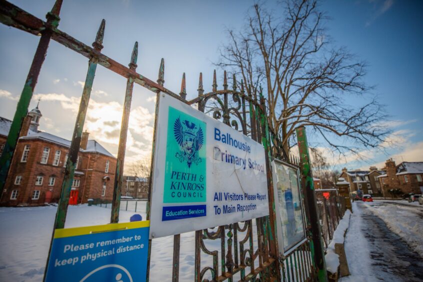 Balhousie School sign on railings with the school, a three store red sandstone building behind