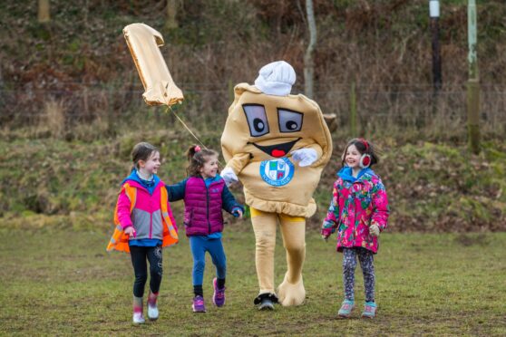 Loons mascot Baxter the Bridie joins in the birthday fun Freya 7, Holly, 5, and Izzy, 7, at Forfar Loch. Image: Steve MacDougall/DC Thomson