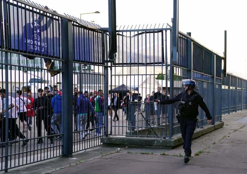 Police use pepper spray against fans outside the ground during the UEFA Champions League Final between Liverpool and Real Madrid at the Stade de France, Paris