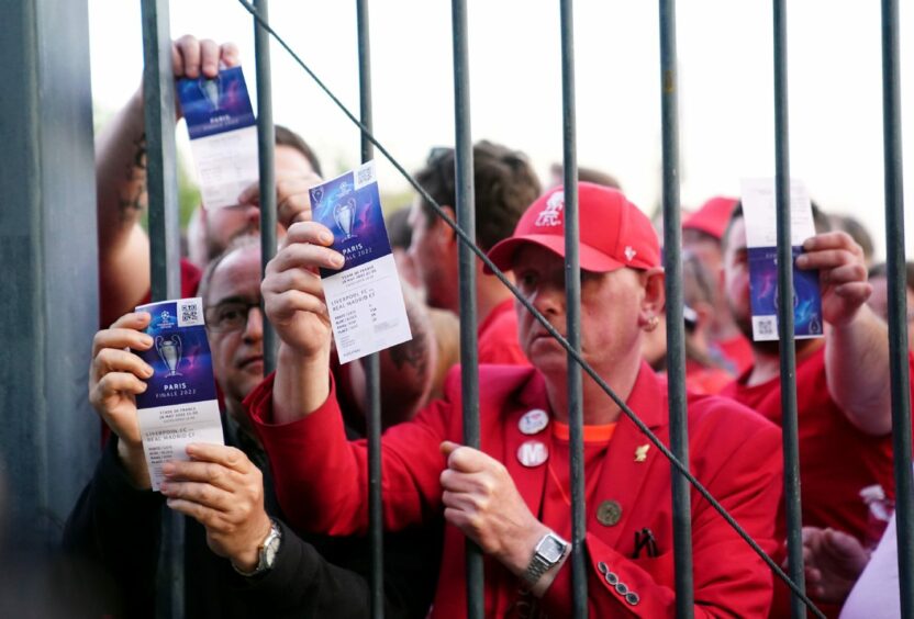 Liverpool fans stuck outside the ground show their match tickets during the UEFA Champions League Final at the Stade de France, Paris.