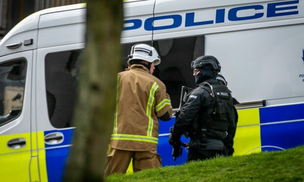Armed police and firefighters at Bonnethill Court in the Hilltown, Dundee.  Image: Steve Brown/DC Thomson