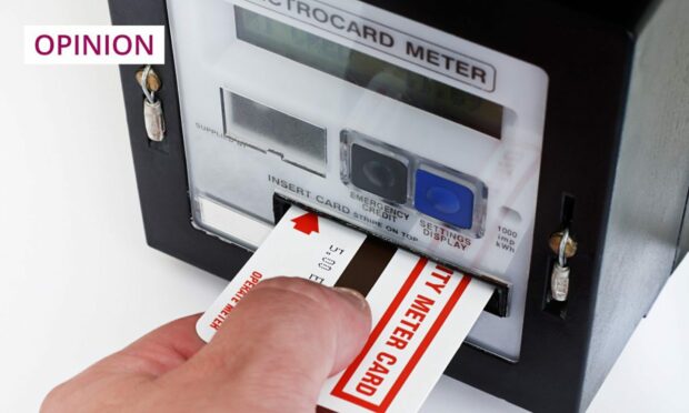 hand feeding a card into a pre-payment meter.