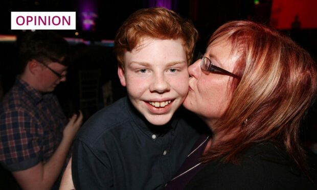 Andrew Batchelor getting a kiss on the cheek from his mother Gillian.