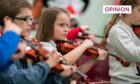 small children playing violins
