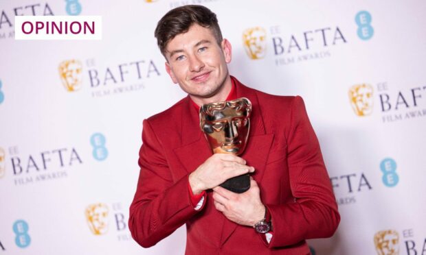 Barry Keoghan holding his BAFTA award