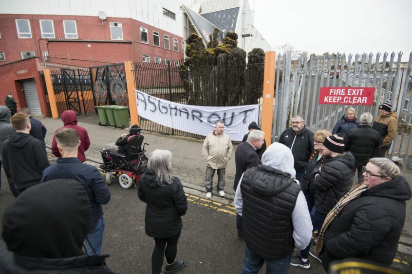 An "Asghar Out" banner is hung outside Tannadice in 2023