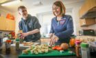 Youth worker Lewis Mackenzie and youth cafe coordinator Gemma Frail prepares food for Cupar Youth Cafe's participants. Image: Mhairi Edwards/DC Thomson