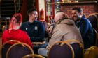 Players Cammy Kerr and Adam Legzdins chatting to some of the people benefitting from the Dinner at Dens project. Image: Mhairi Edwards/DC Thomson