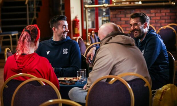 Players Cammy Kerr and Adam Legzdins chatting to some of the people benefitting from the Dinner at Dens project. Image: Mhairi Edwards/DC Thomson