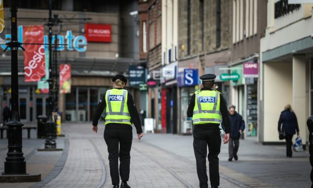 Two males have been charged with assaulting plain-clothes police officers in Dundee. 