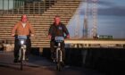 Dundee Ride-On manager Brian Bellman and Peter Docherty, former CEO of Embark Platform, trying out the e-bikes at Dundee Waterfront in November 2021.