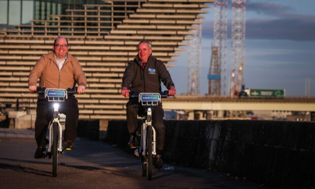 Dundee Ride-On manager Brian Bellman and Peter Docherty, former CEO of Embark Platform, trying out the e-bikes at Dundee Waterfront in November 2021.