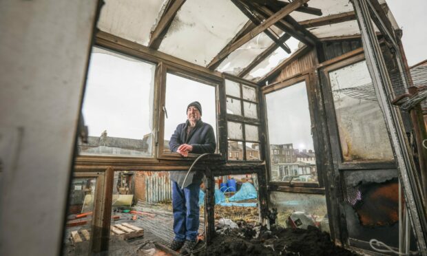 Allotment letting agent George McGill by the burnt-out greenhouse. Image: Mhairi Edwards/DC Thomson