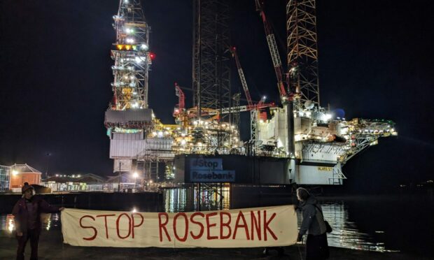 Last night the messages 'Stop Rosebank', 'No new oil' and 'Fossil fuels are killing us' were projected onto the Valaris 121 oil rig in Dundee harbour. Image: Stop Rosebank and Extinction Rebellion Dundee.