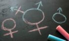 Chalk symbols for male, female and transgender on a blackboard.