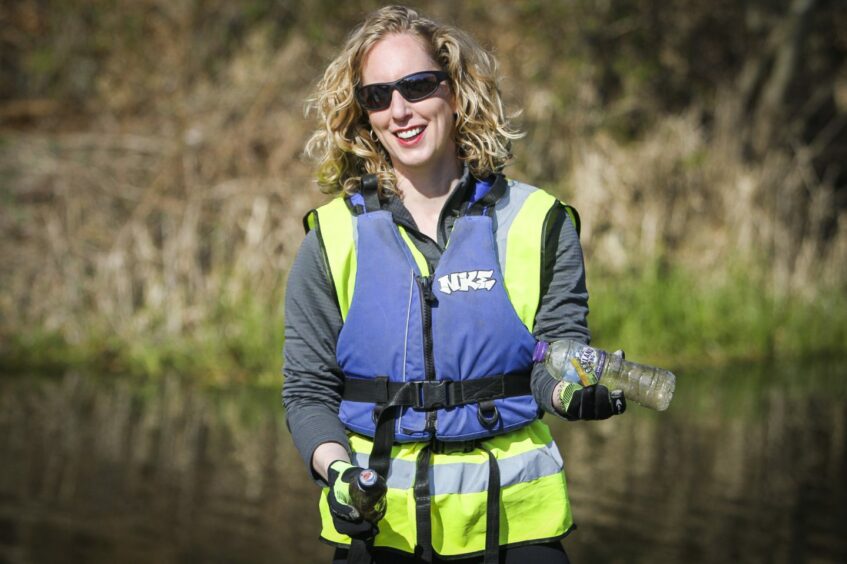 Scottish Greens co-leader Lorna Slater picking up plastic bottles in a riverside litter pick