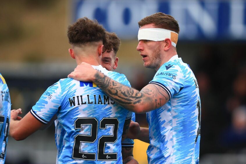 Lee Ashcroft celebrates a goal at Cove Rangers with team-mate Ben Williamson. Image: David Young/Shutterstock