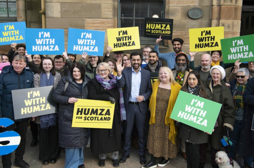 Humza Yousaf surrounded by a large crowd holding 'I'm with Humza' placards.
