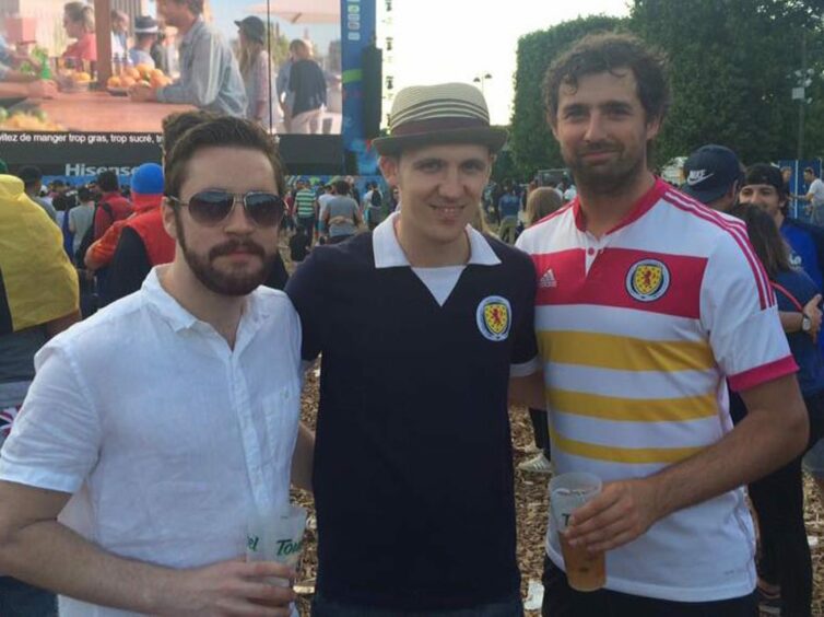 Ross Cunningham and friends wearing Scotland tops at football matches.