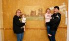 Kayleigh Ross and partner Liam Smith with their children Ava, 5, and one-year-old Macy beside the Abbey mural. Image: Paul Reid