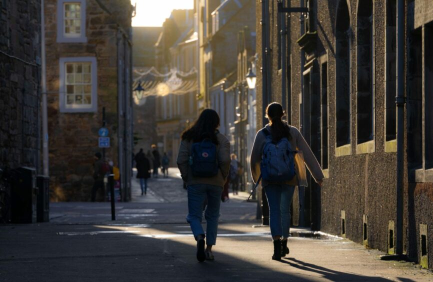 Students walking in down St Andrews street.