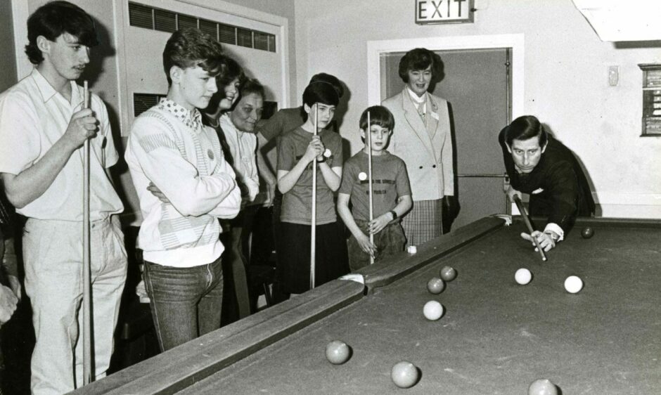 Charles picks up the royal cue and plays snooker at Menzieshill Community Centre. Image: DC Thomson.