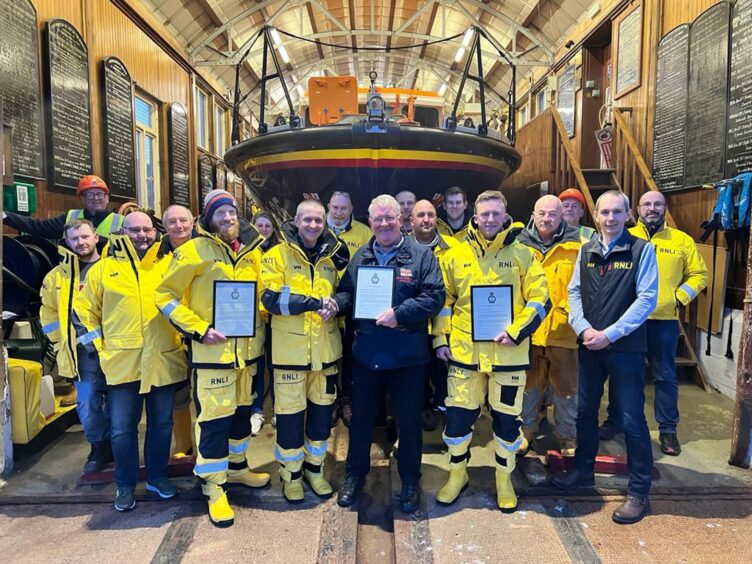 Arbroath RNLI crew lined up in front of the town's lifeboat