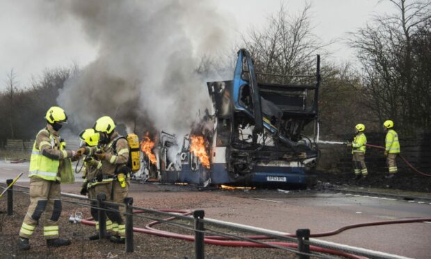 Firefighters tackle the school bus fire last year. Image: Alan Richardson