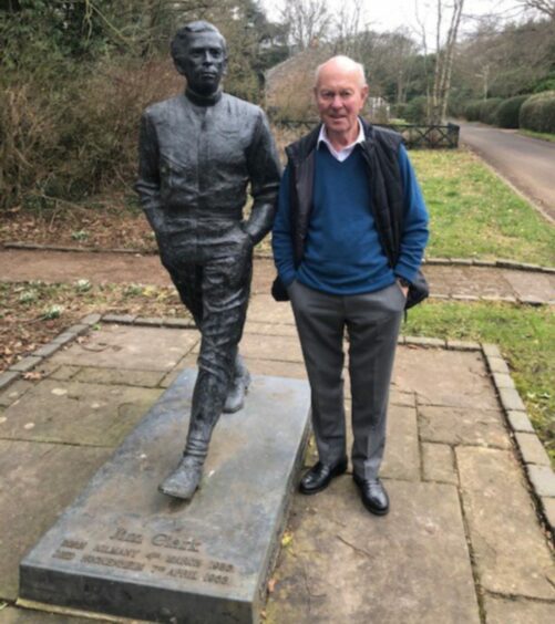 Doug Niven, cousin of Jim Clark, at Clark statue in Kilmany, Fife.