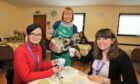 Holly Turner serves up a cuppa to Juana Sahagon from Voluntary Action Angus and Hong Zhang of Angus Council Vibrant Communities Team  Image: Gareth Jennings/DC Thomson