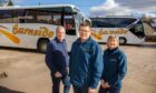 Gary Rutherford with parents David and Fiona at Earnside Coaches' yard in Glenfarg. Image: Kenny Smith/DC Thomson.