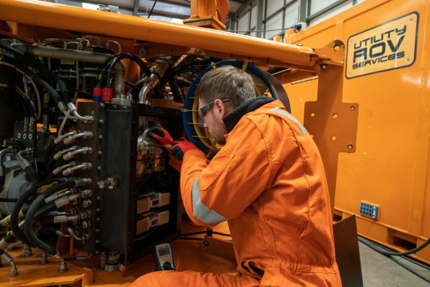 A Utility ROV employee at work on a piece of the firm's high-tech equipment. Image: Kenny Smith/DC Thomson.