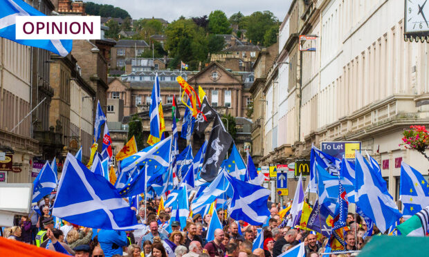 Independence activists wave Scotland flags during rally in Dundee.