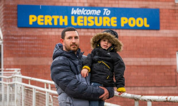 Chris Ness, with son Lucas (4), is petitioning to keep Perth Leisure Pool open. Image: Steve MacDougall/DC Thomson