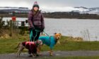 Fiona Stewart with her dogs Blue and Indy were left covered in sewage from the river on the Loch Leven circular path in February. Image: Steve Brown/DC Thomson.