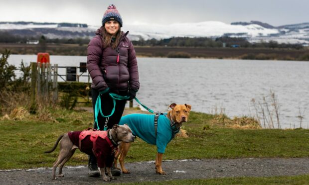 Fiona Stewart with her dogs Blue and Indy were left covered in sewage from the river on the Loch Leven circular path in February. Image: Steve Brown/DC Thomson.