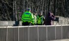 Police on the A911 Leslie Bridge after a man's body was found. Image: Steve Brown/DC Thomson