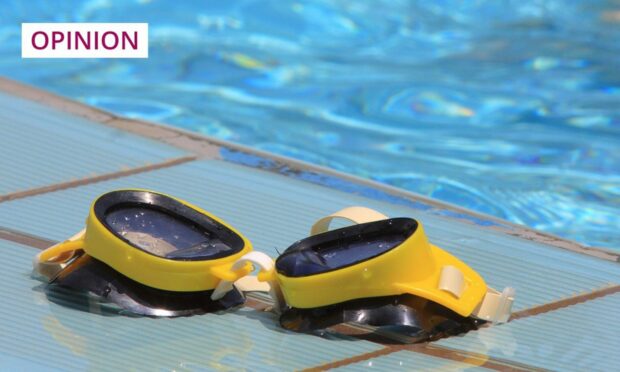 swimming goggles by a poolside.