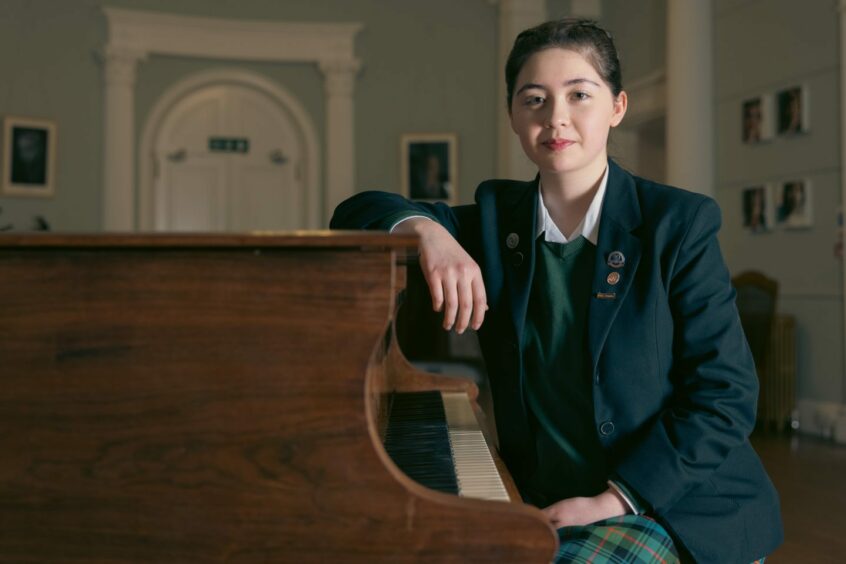 A Kilgraston senior pupil by a piano. Kilgraston is one of the best Perth and Kinross schools.