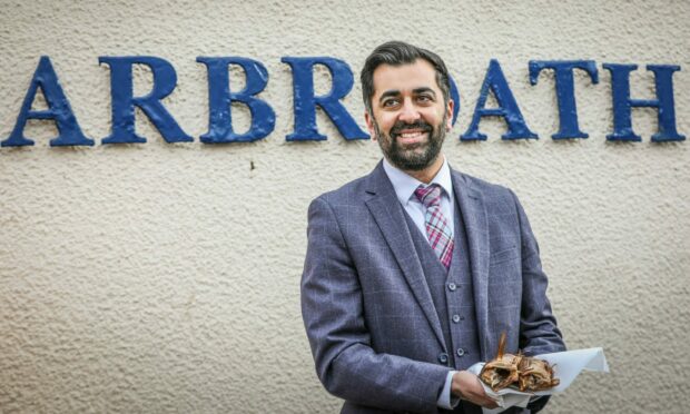 Humza Yousaf enjoys some Arbroath smokies during his visit to Angus. Image: Mhairi Edwards/DC Thomson.