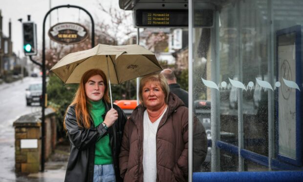 Erin and Brenda Lees at the Strathmartine Road bus stop where a man overdosed. Image: Mhairi Edwards/DC Thomson
