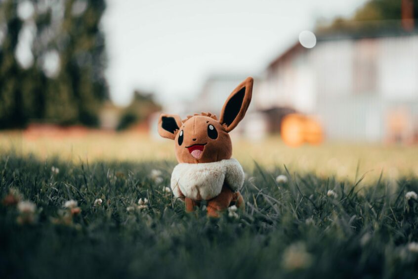 Pokemon character Eevee enjoying a rest in the long grass