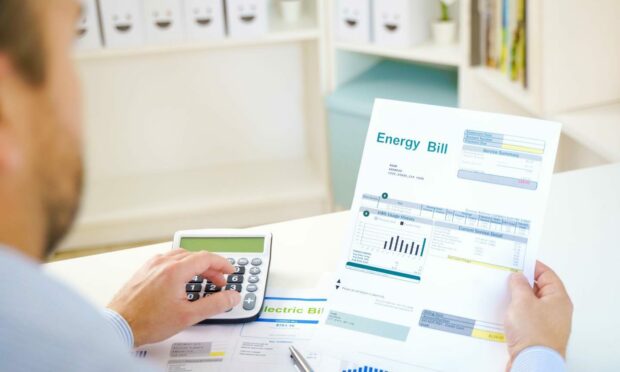 Man calculating electric bill statement and home energy consumption. Image: Shutterstock